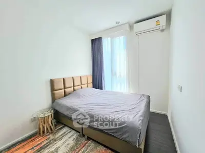 Modern bedroom with stylish bed and natural light in a contemporary apartment.