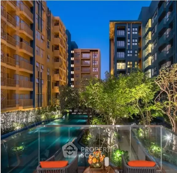 Luxurious residential complex with pool and garden view at dusk