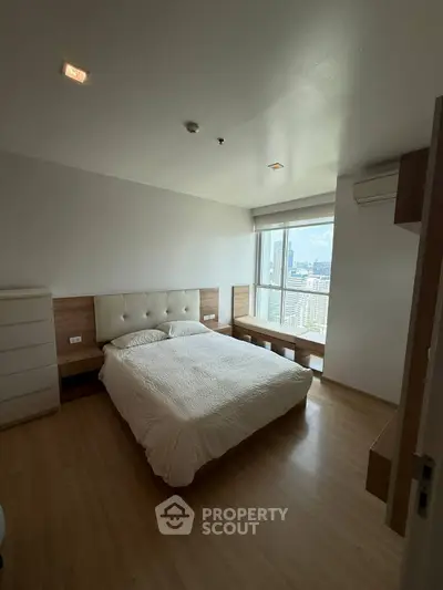 Modern bedroom with city view, featuring wooden flooring and minimalist design.