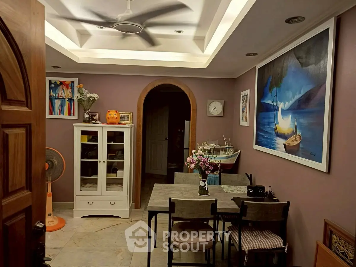 Charming dining area with modern decor and artistic wall paintings.