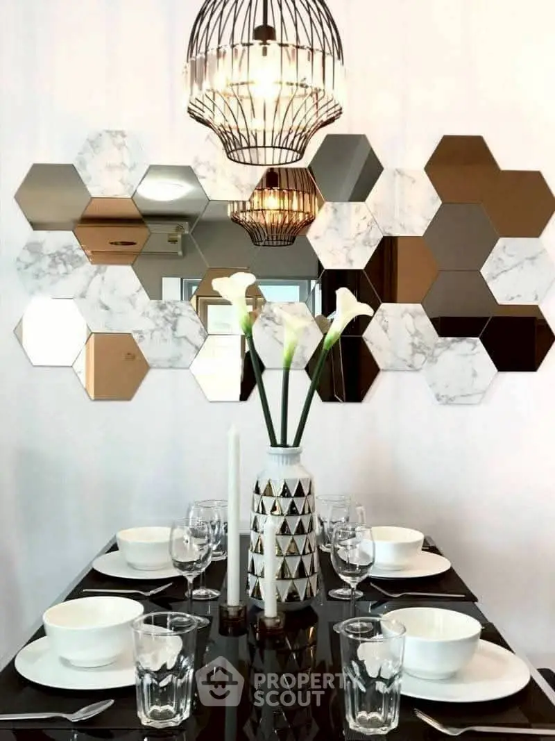 Elegant dining area with modern decor and hexagonal mirror tiles.