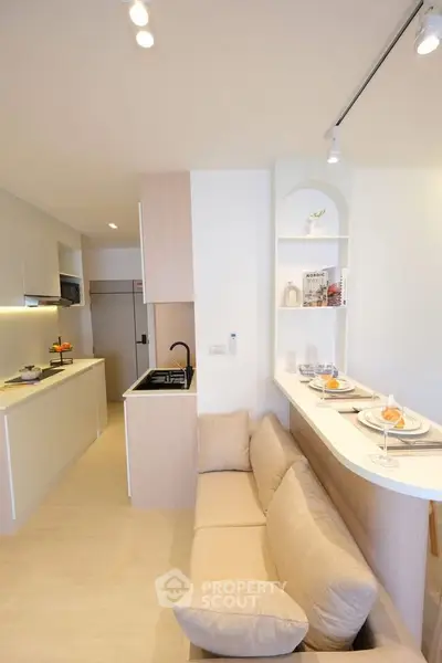 Modern open-layout kitchen with cozy seating area and elegant decor