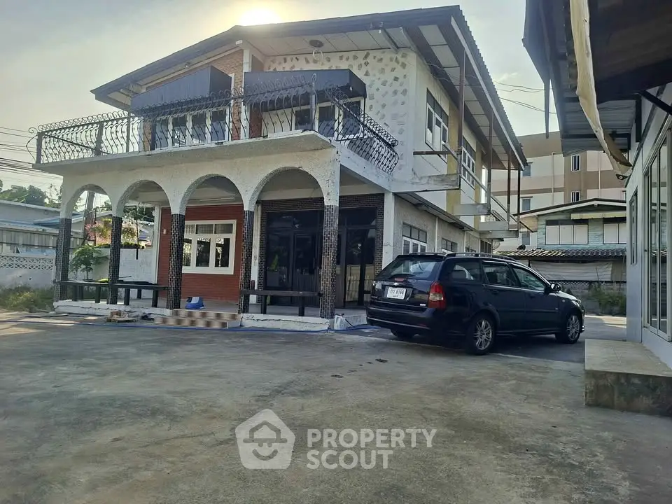 Charming two-story house with spacious driveway and elegant balcony