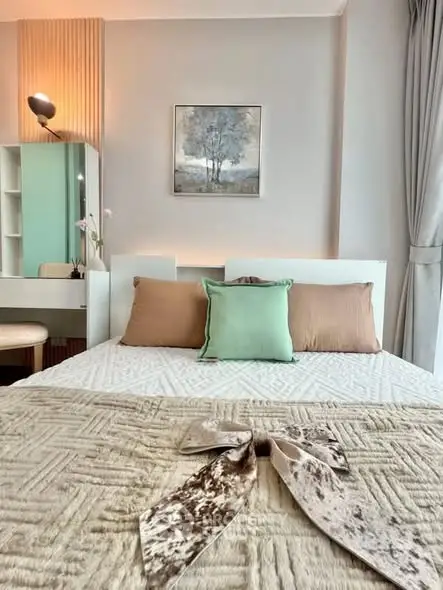Elegant bedroom with stylish decor and cozy bedding in modern apartment.