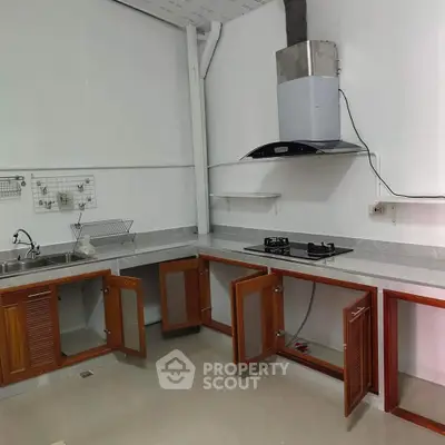 Modern kitchen with open cabinets and gas stove in a sleek design