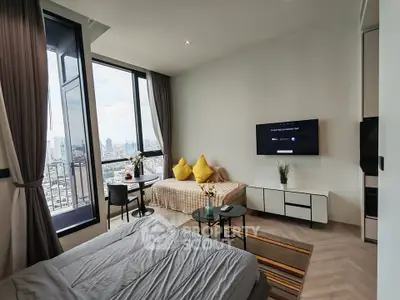 Modern studio apartment with city view, featuring cozy living area and stylish decor.