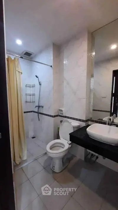 Modern bathroom with shower and sleek fixtures in contemporary apartment