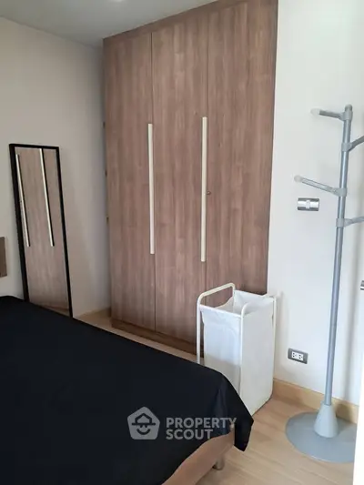 Modern bedroom with sleek wardrobe and minimalist decor