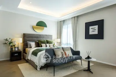 Luxurious modern bedroom with stylish decor and cozy seating area