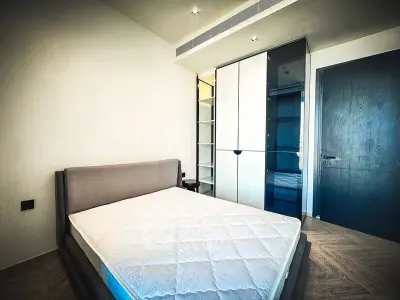 Modern bedroom with sleek wardrobe and minimalist design, perfect for urban living.