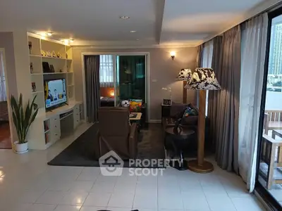 Spacious living room with modern decor and balcony access in a stylish apartment.