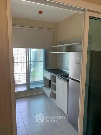 Modern kitchen with sleek appliances and large window view