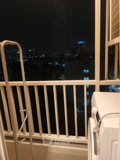 Charming balcony with city night view and washing machine, perfect for urban living convenience.