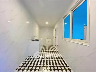 Sleek modern kitchen with checkered floor and white cabinetry