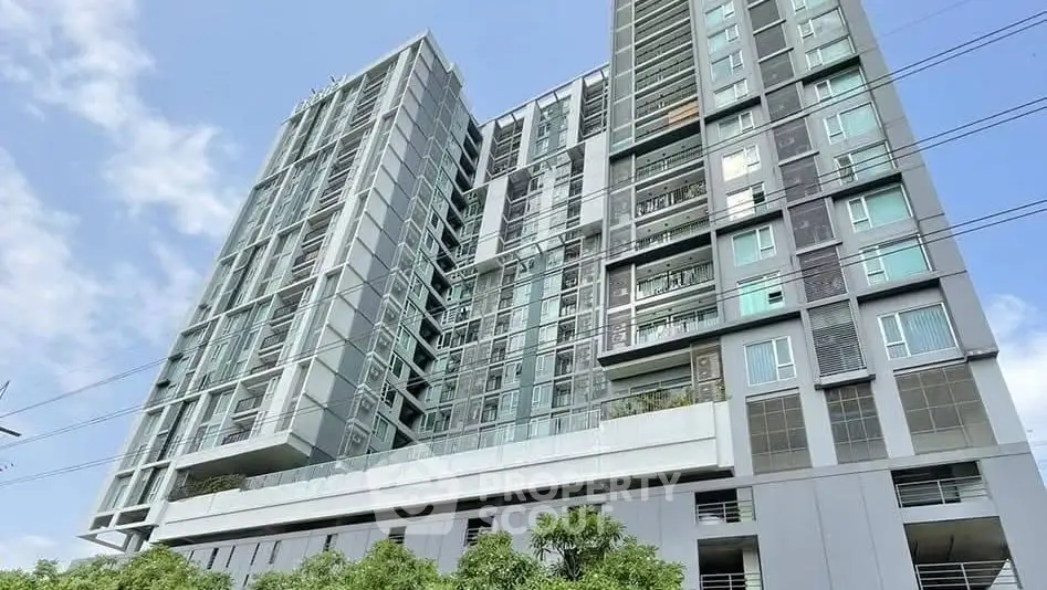 Modern high-rise building with sleek architecture and large windows, perfect for urban living.