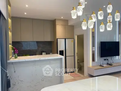 Modern kitchen with marble countertops and elegant lighting in a stylish apartment.