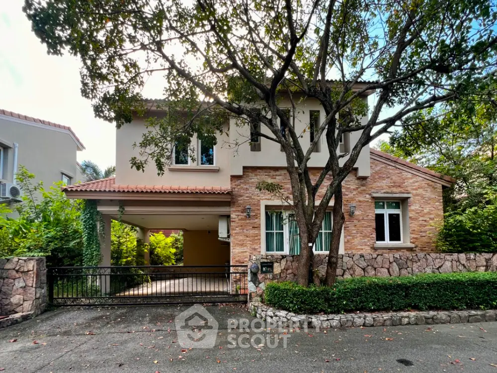 Charming two-story house with stone facade and lush greenery in a serene neighborhood.