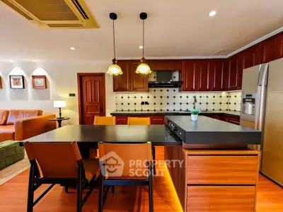Luxurious kitchen with modern appliances and elegant wooden cabinetry in open layout design.