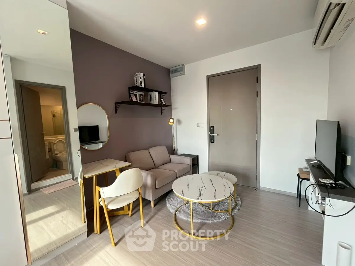 Modern living room with stylish furniture and neutral tones, featuring a cozy sofa and elegant coffee table.