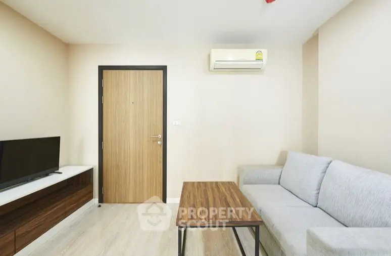 Modern living room with sleek furniture and air conditioning in a cozy apartment.