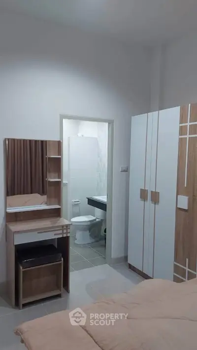 Modern bedroom with ensuite bathroom and stylish furniture