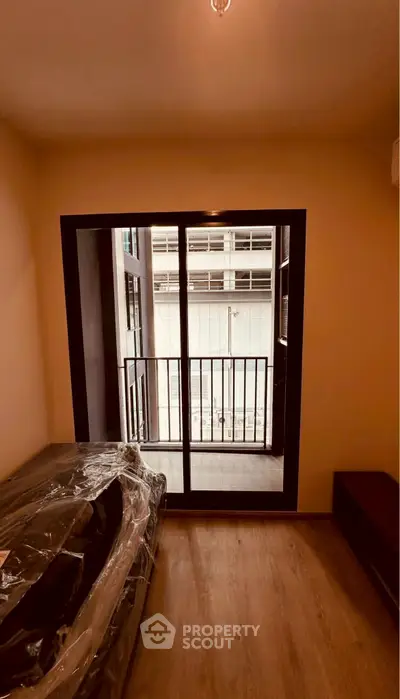 Cozy bedroom with balcony access in modern apartment