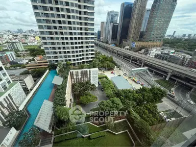 Stunning cityscape view from high-rise building with pool and lush greenery
