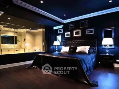 Luxurious dark-themed bedroom with elegant decor and ambient lighting