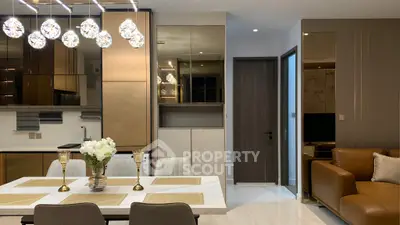 Luxurious modern living and dining area with elegant lighting and stylish decor.