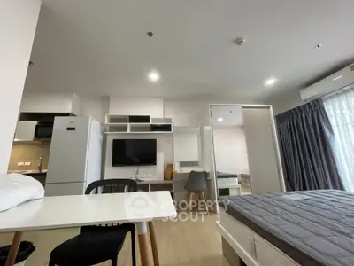 Modern studio apartment with open layout, featuring kitchen, dining, and sleeping area.