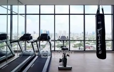 Modern gym with panoramic city views and fitness equipment