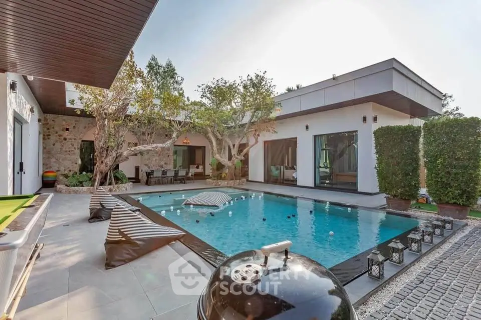 Luxurious modern villa with private pool and stylish outdoor seating area.