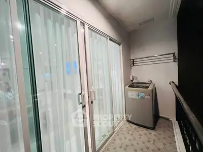 Modern balcony with washing machine and sliding glass doors