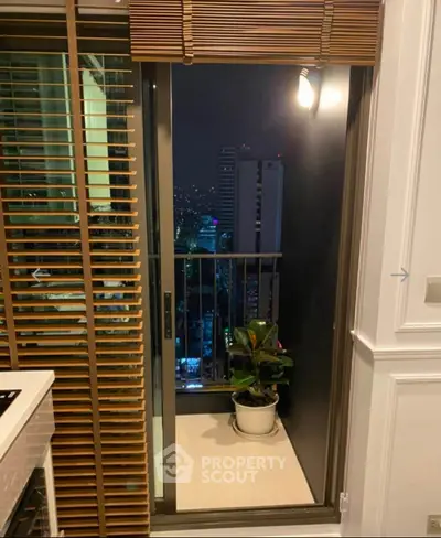 Chic urban balcony with night city view and stylish wooden blinds.