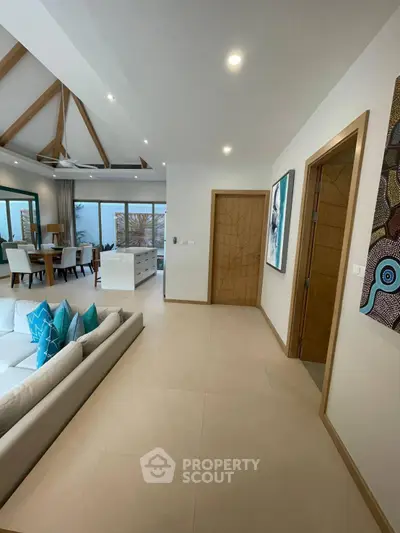 Luxurious open-plan living room with modern decor and stunning ocean view.