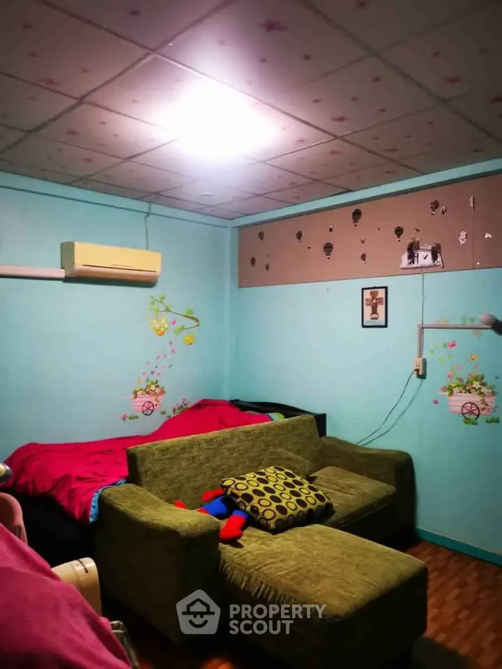 Cozy bedroom with vibrant decor and comfortable seating area, perfect for relaxation.