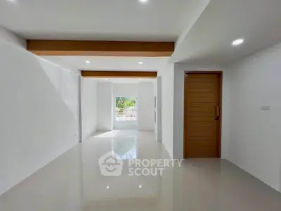 Spacious modern living room with glossy floors and natural light