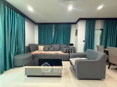 Spacious living room with modern gray sofa and elegant teal curtains
