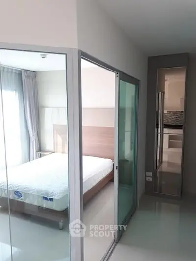 Modern bedroom with glass sliding doors and natural light