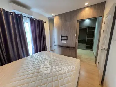 Modern bedroom with walk-in closet and natural light