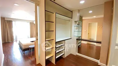 Spacious bedroom with elegant walk-in closet and natural light