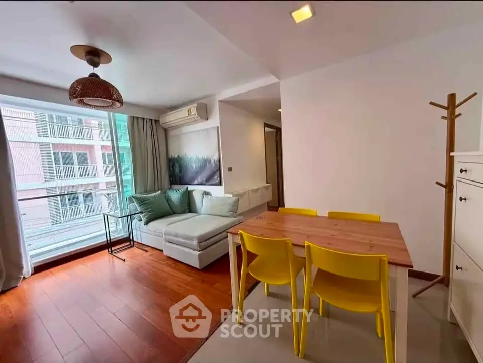 Modern living room with stylish decor and natural light in a cozy apartment.
