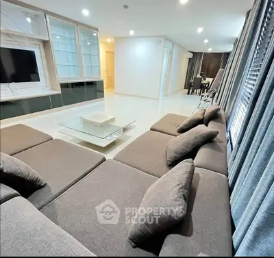 Spacious modern living room with plush sectional sofa and sleek entertainment center