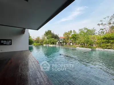Luxurious outdoor pool with serene garden view in modern residential area