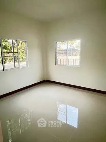 Bright empty room with glossy tiled floor and large windows, perfect for customization.