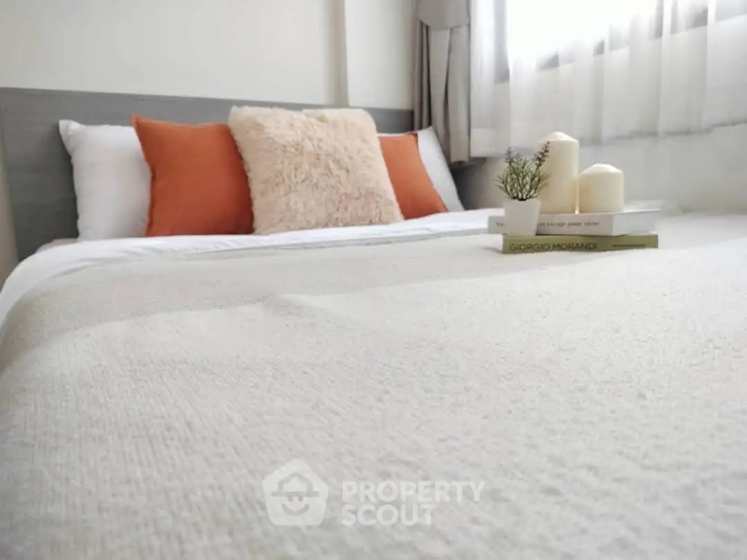 Cozy bedroom with plush pillows and soft lighting, perfect for relaxation.