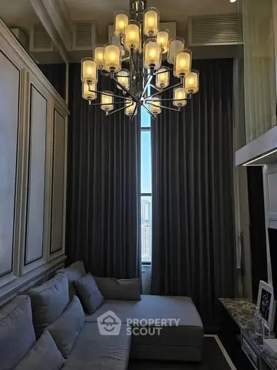 Luxurious living room with high ceiling and elegant chandelier