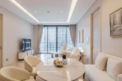 Luxurious modern living room with elegant decor and large windows offering city views.