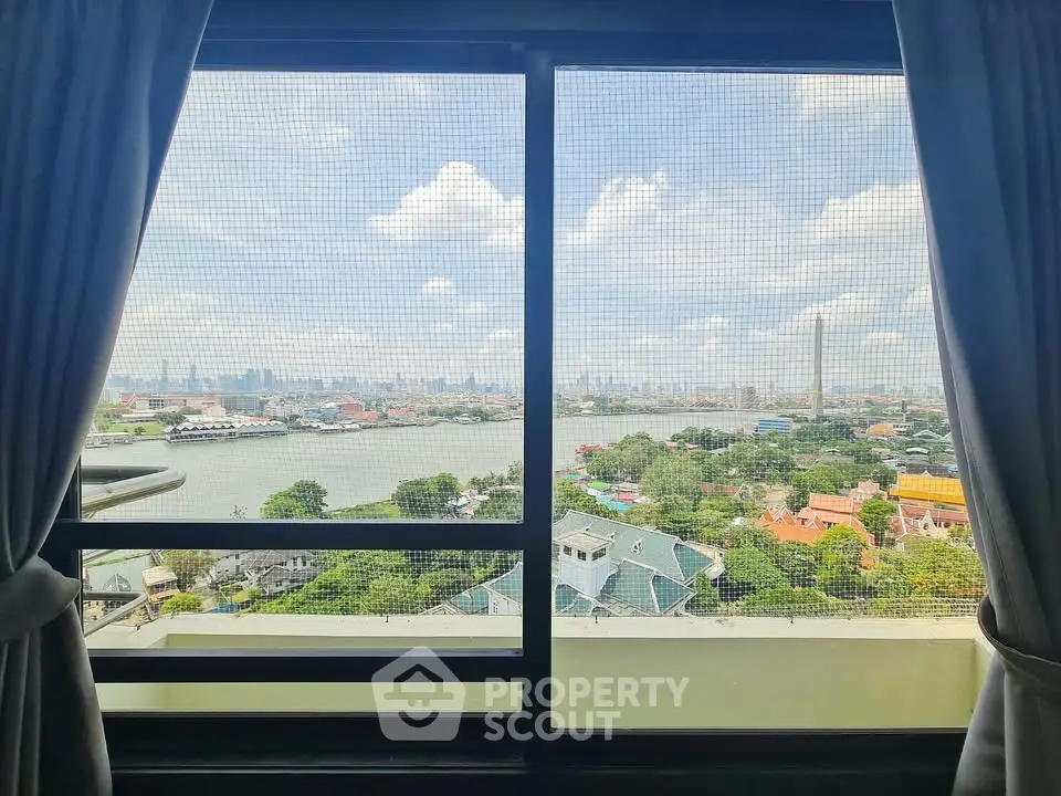 Stunning river and cityscape view from high-rise apartment window.