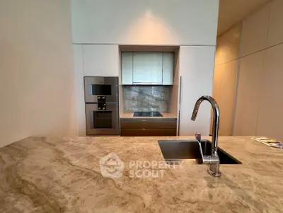 Modern kitchen with sleek marble countertops and built-in appliances